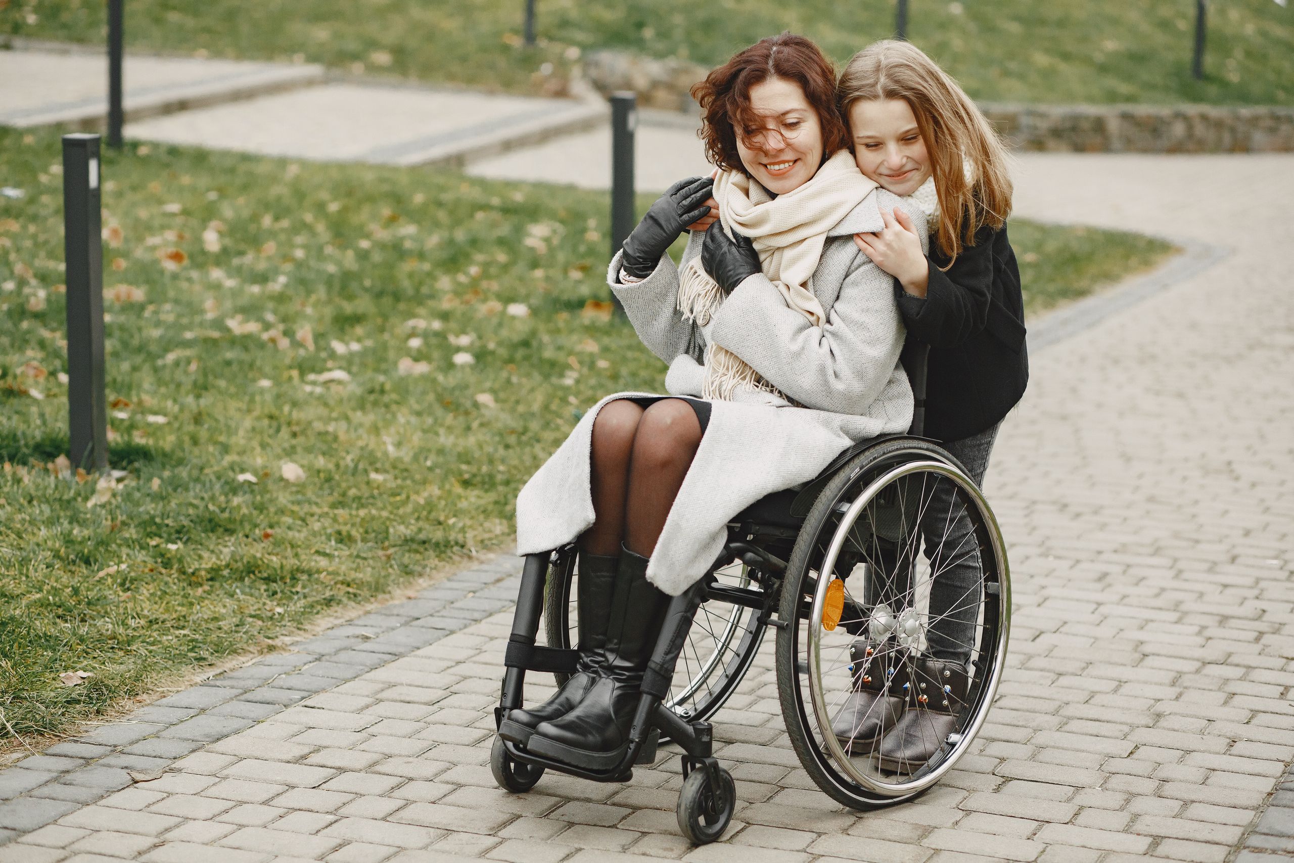 A joyful family moment shared by a mother and daughter outdoors.